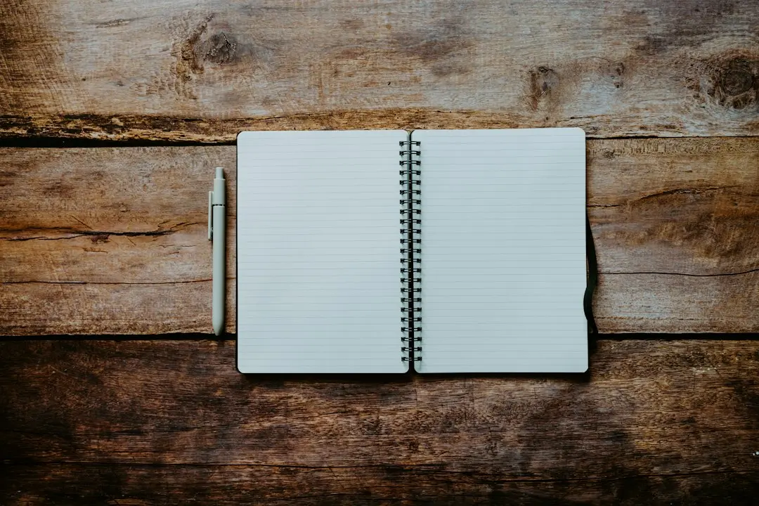 An open notebook and a pen on a wooden table, ready for a checklist before choosing an IPTV provider like Mediaspelare